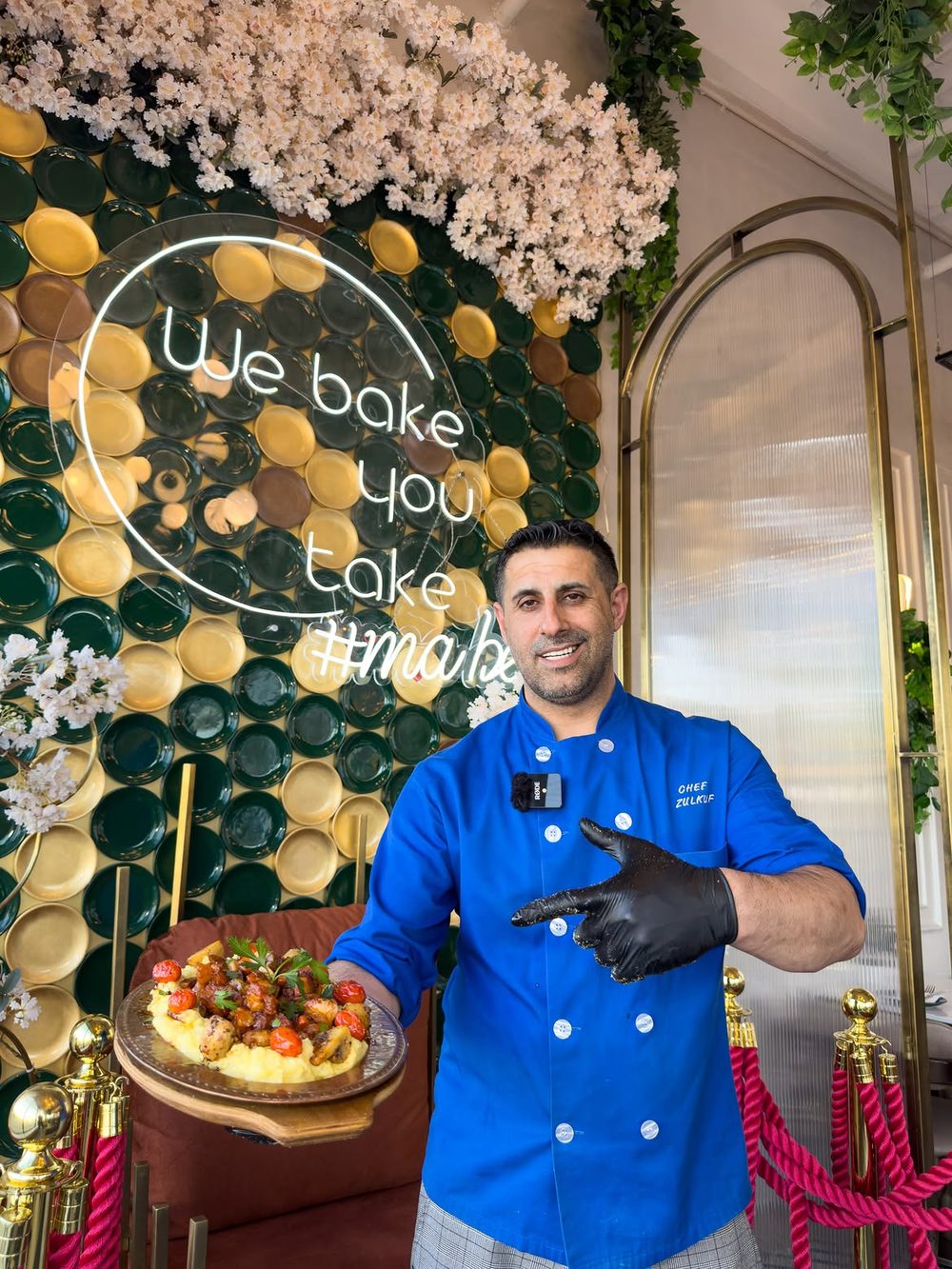 Chef Zülküf holding a freshly plated dish at Mabelle